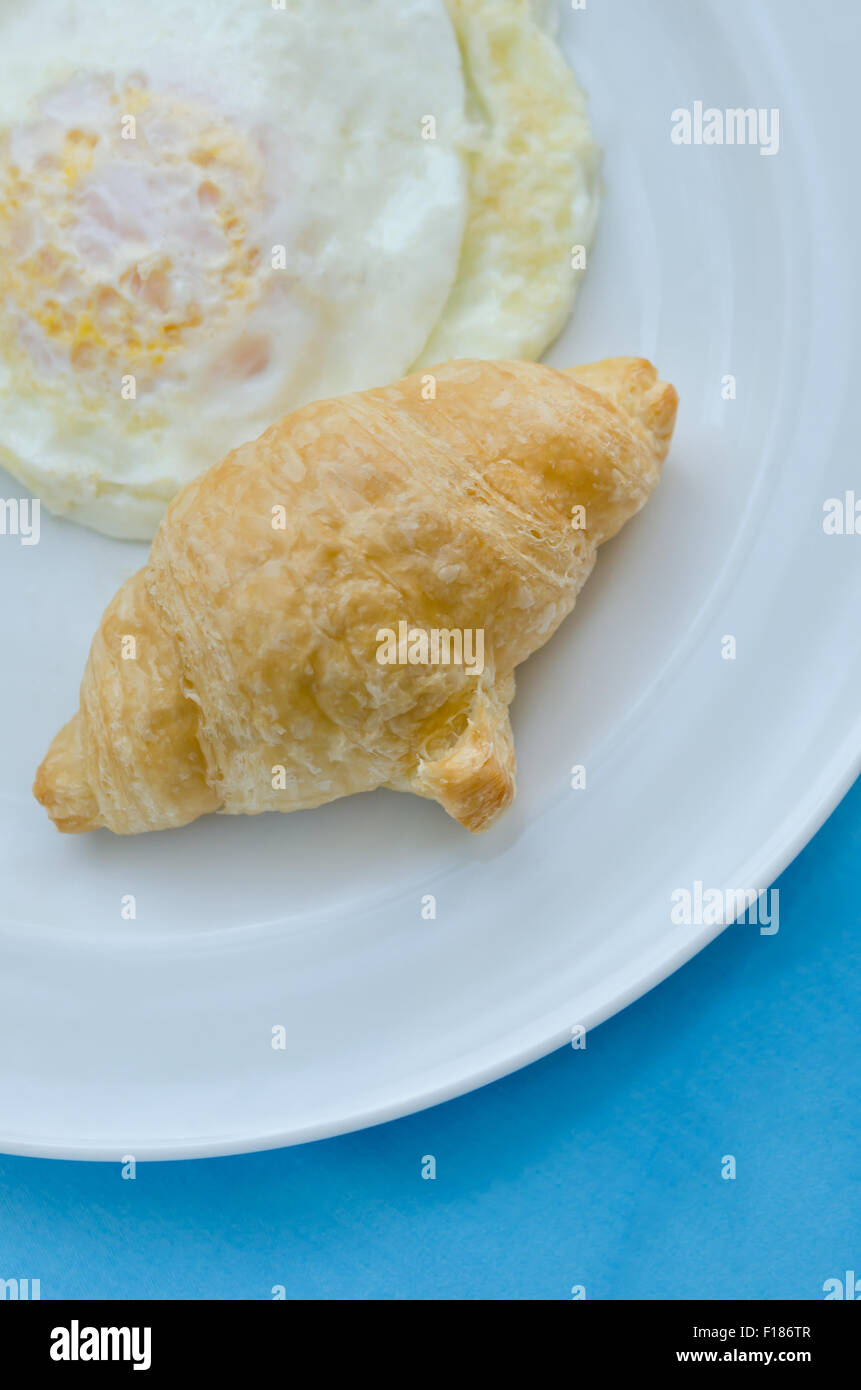 Ein Frühstück Croissant mit Spiegelei auf Teller Stockfoto