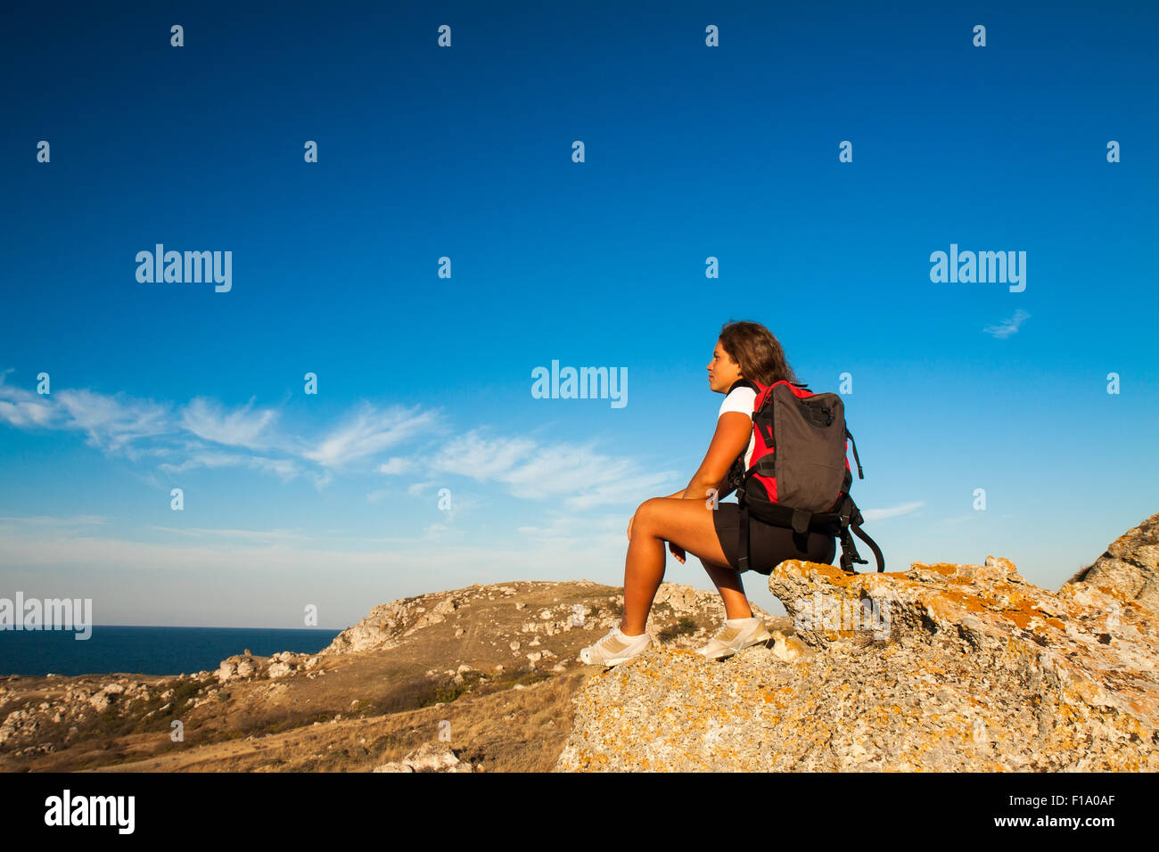 Frau Wanderer liegt am Berg Küstenfels Stockfoto