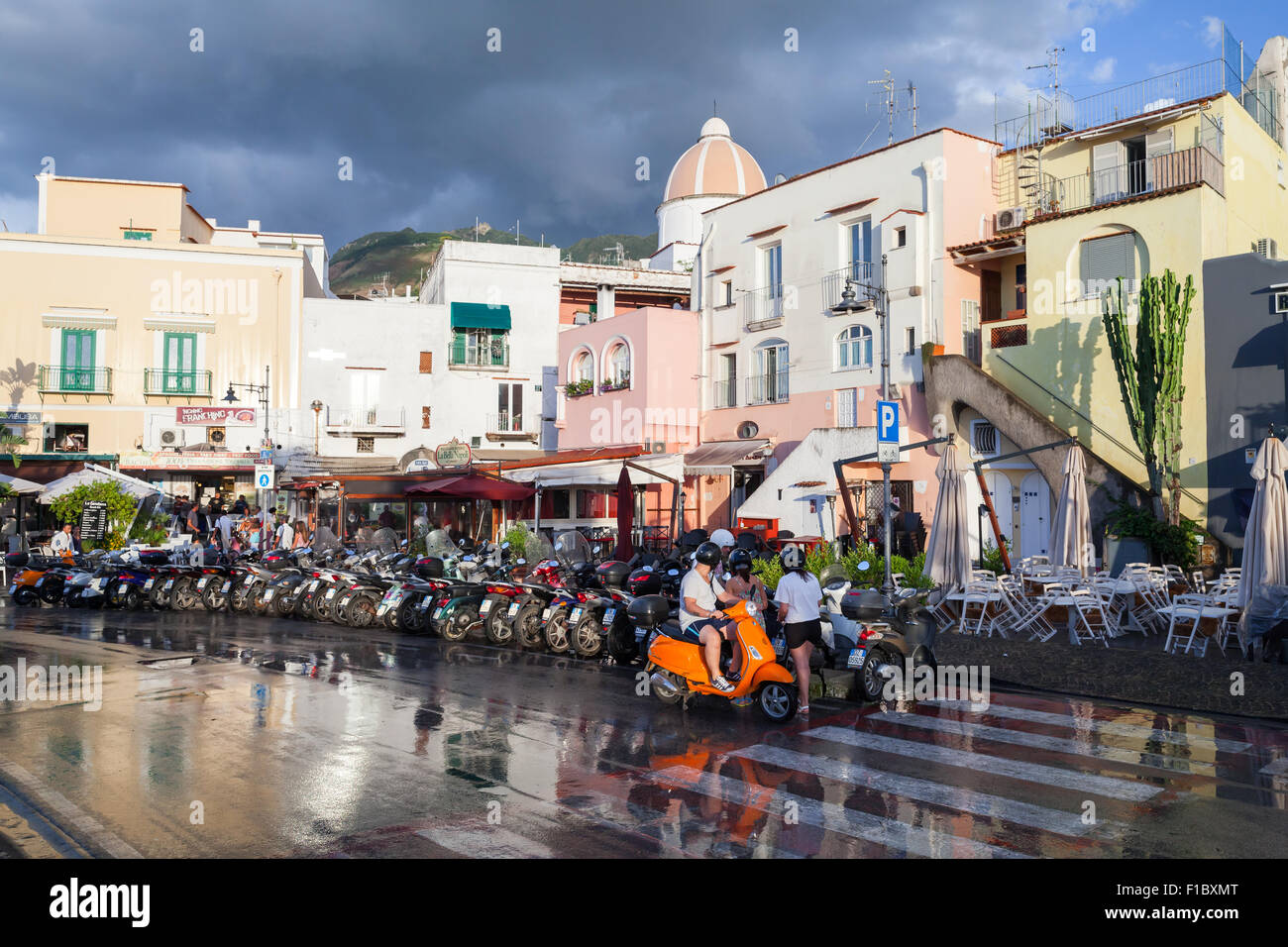 Forio, Italien - 16. August 2015: Nasse Straße nach dem Regen mit geparkten Roller am Straßenrand. Forio, Ischia Stockfoto