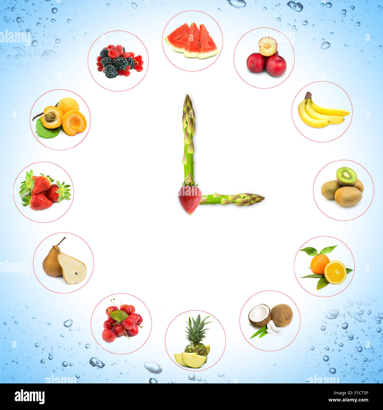 Uhr mit Obst und Gemüse und Hände des Spargels Stockfoto
