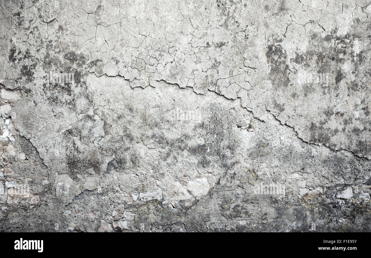Alten verwitterten Betonwand mit Schäden und Risse auf grauen Stuck, Hintergrundtextur Stockfoto
