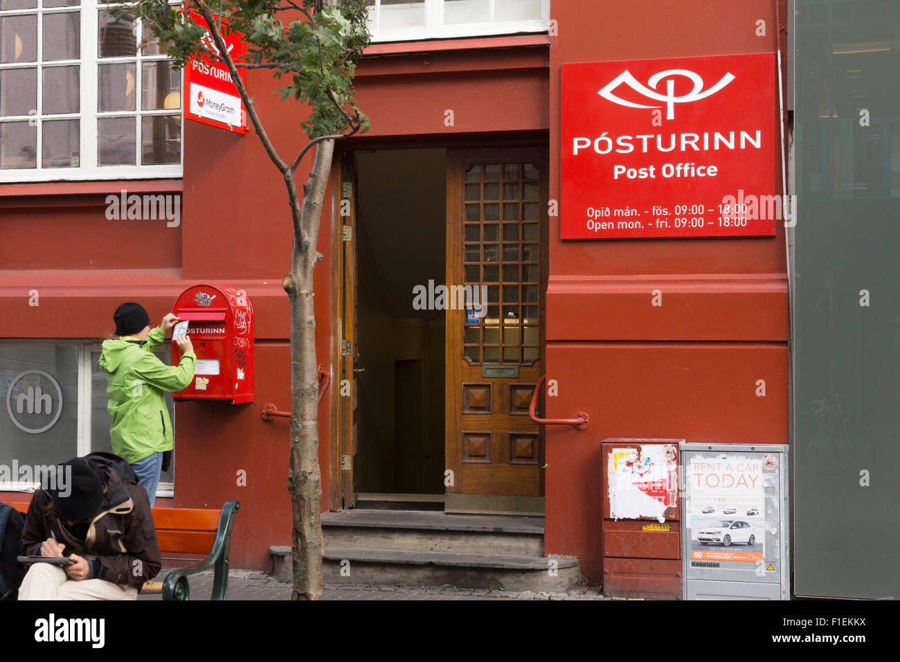 Eine Frau, die Postkarten bei der Hauptpost ( Pósturinn) im Zentrum von Reykjavik, Island, postamt Stockfoto