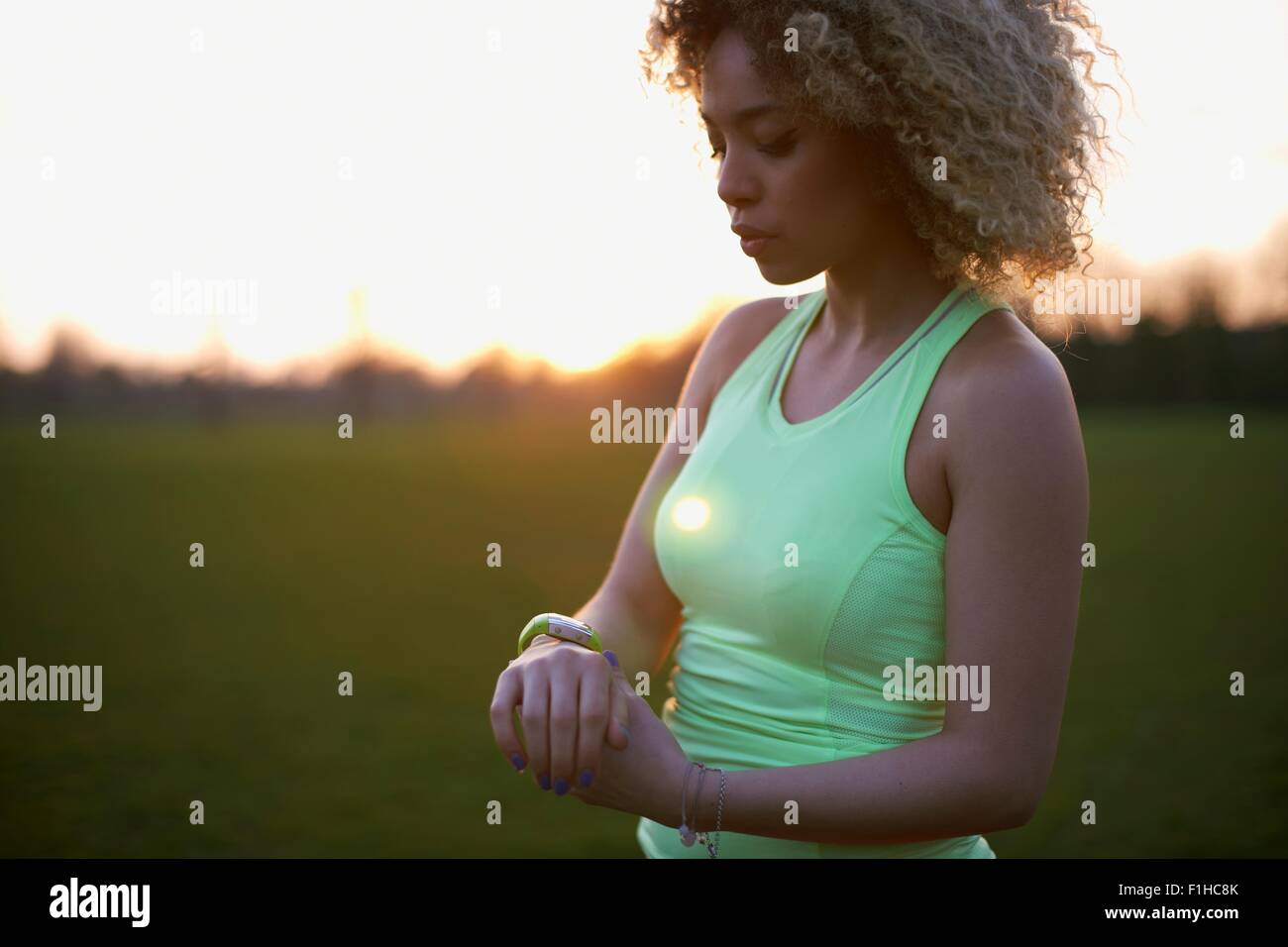 Porträt der Frau, die Überprüfung der Uhr nach dem Training im park Stockfoto