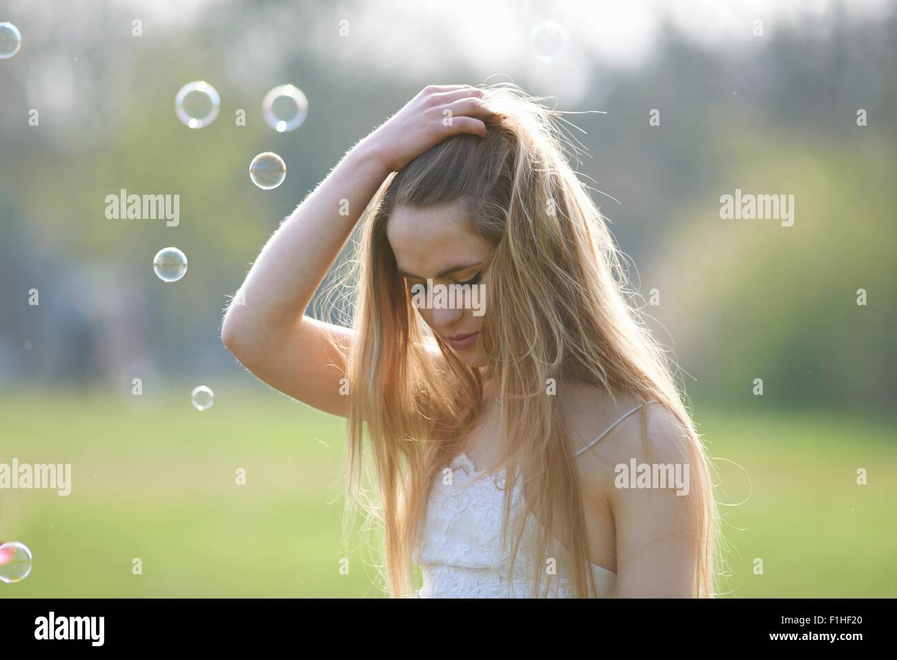 Porträt von Teenager-Mädchen mit Hand im Haar im park Stockfoto