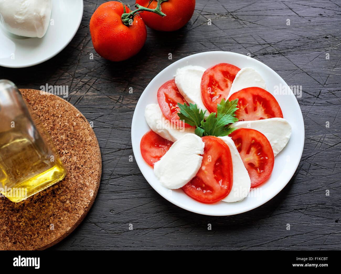 Salat Mozzarella mit Tomaten auf einem hölzernen Hintergrund Stockfoto