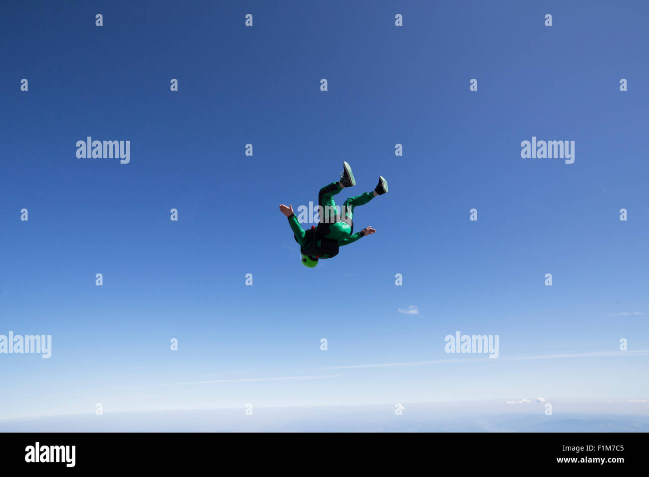Freefly Fallschirmspringer trainiert Kopf über Fluglage im Freifall mit 130 km/h in den blauen Himmel. Stockfoto