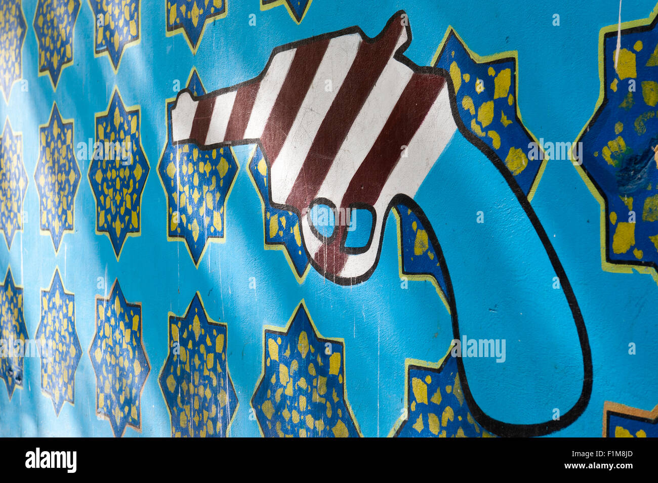 Graffiti auf eine Mauer, Symbol, amerikanische Revolver und iranischen Muster, ehem. Botschaft der Vereinigten Staaten von Amerika in Teheran Stockfoto
