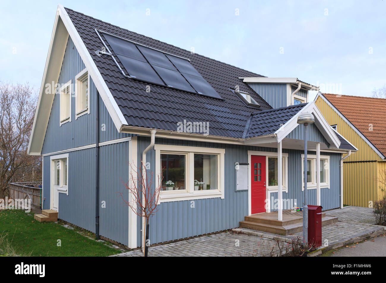 Typische schwedische freistehende Mittelschicht Holzhaus mit modernen Dach Solaranlagen in Floda, Schweden Model Release: Nein Property Release: Nein. Stockfoto