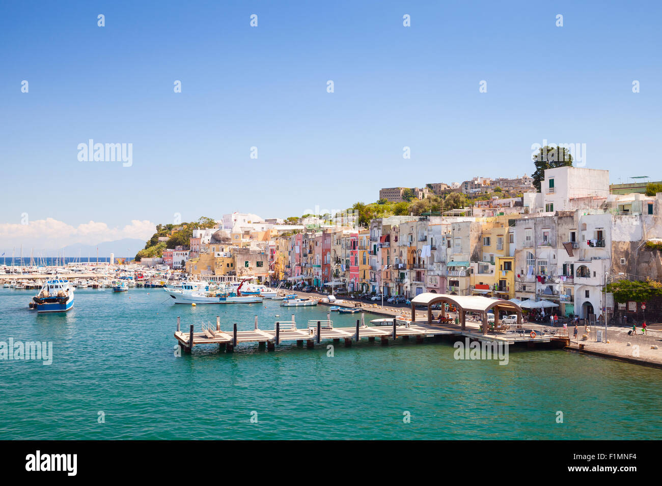 Kleine italienische Küstenstadt Stadtbild mit bunten Häusern und Piers. Hafen von Procida Insel, Golf von Neapel, Italien Stockfoto