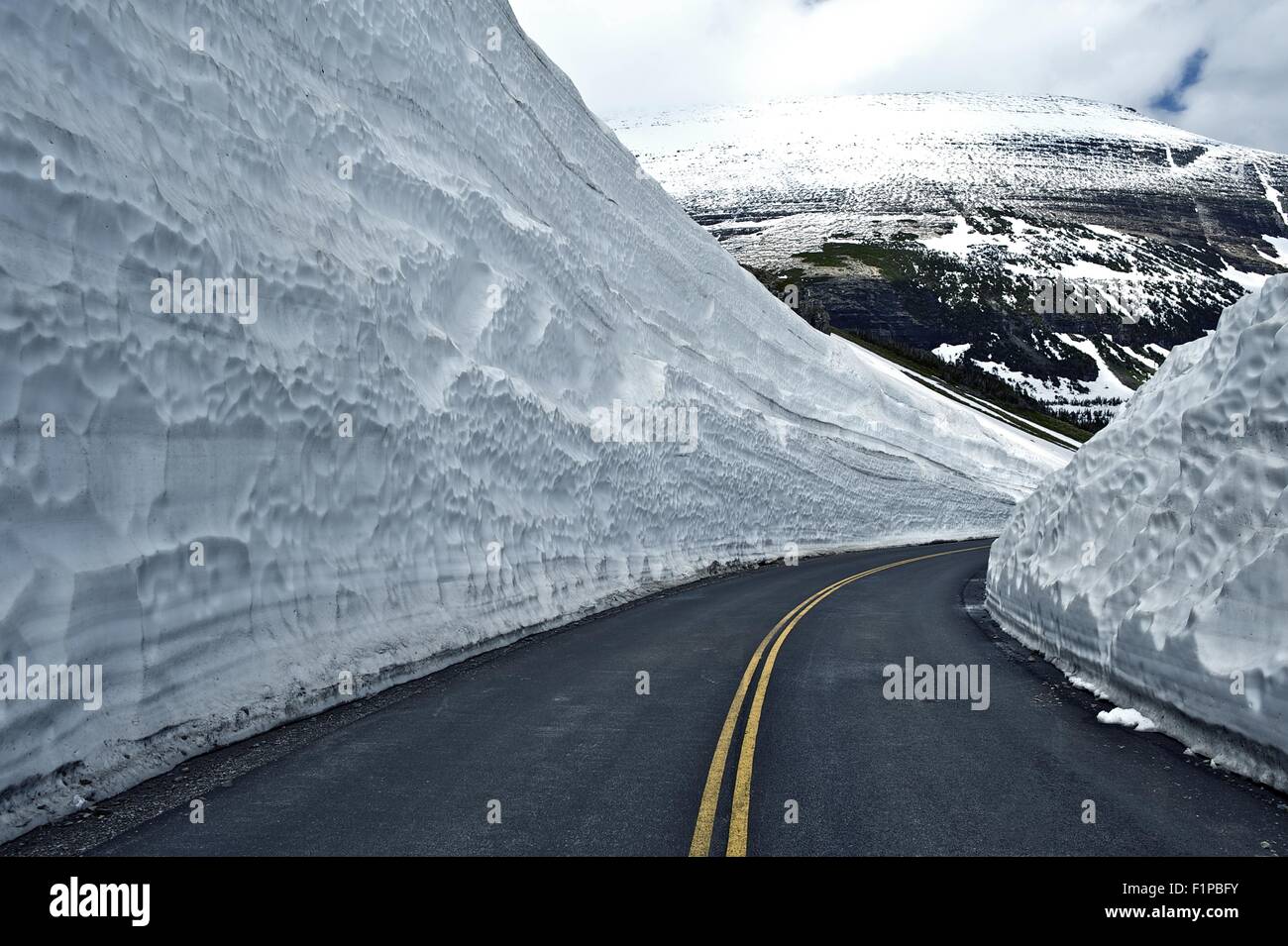 Straße durch Schnee - große Schneefelder auf Seiten der Straße. Glacier Nationalpark - berühmte Straße, so. Montana, USA. Montana Pho Stockfoto
