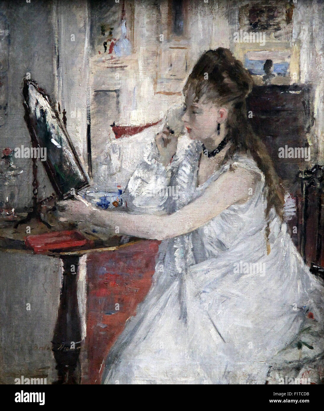Junge Frau, die ihr Gesicht pudert, 1877 Ölgemälde einer Frau an ihrem Frisiertisch von Berthe Morisot (1841-1895) Stockfoto