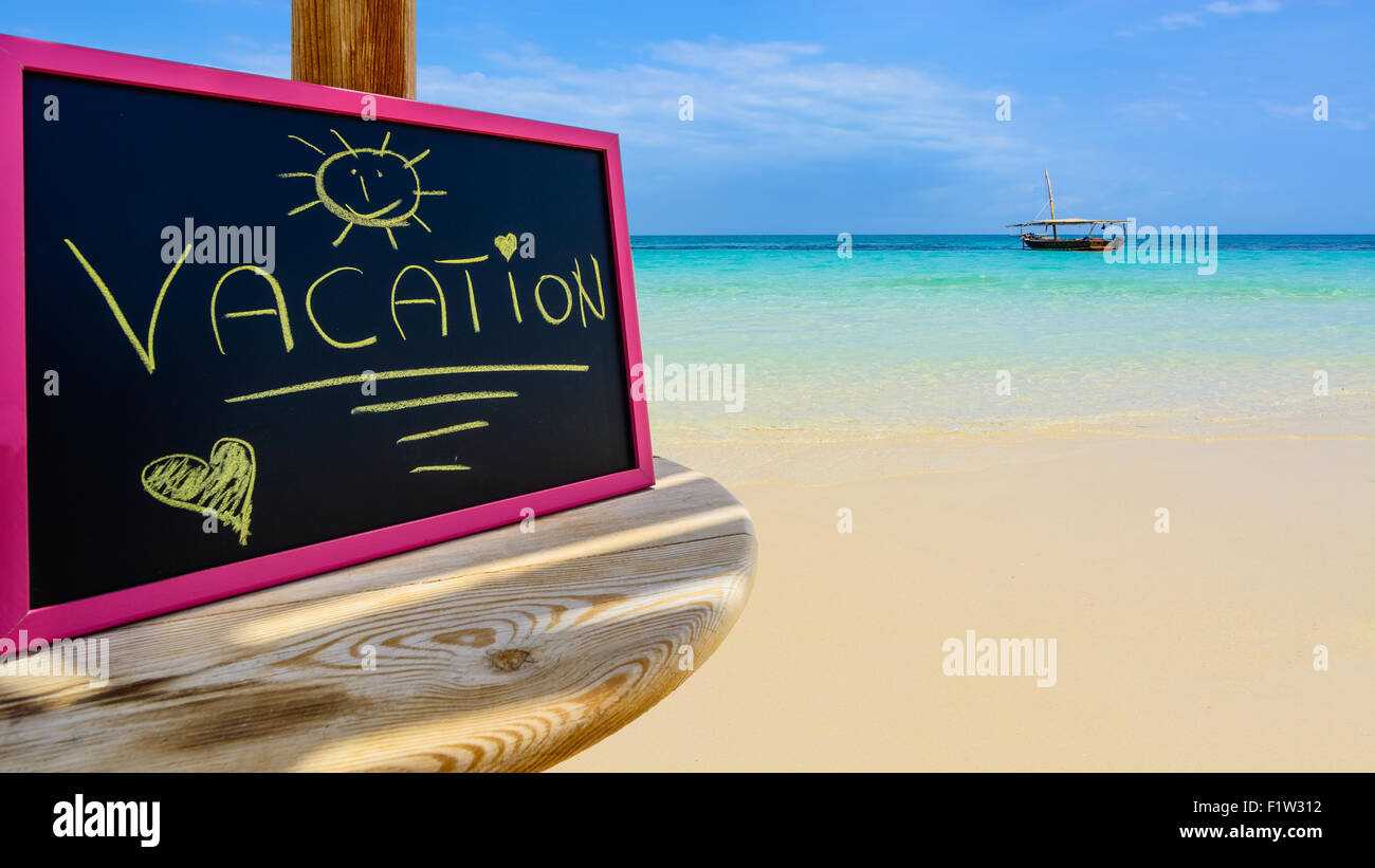Auf dem Bild ein Zanzibar Beach ist eine kleine Tafel mit den Worten "Urlaub" am Nachmittag. Stockfoto