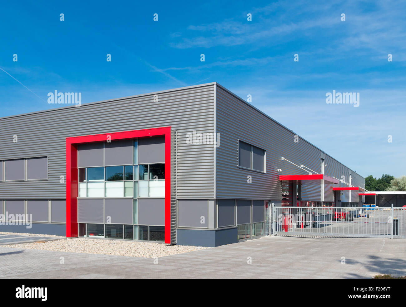 neugebaute moderne rote Lagerhalle mit Büros Stockfoto