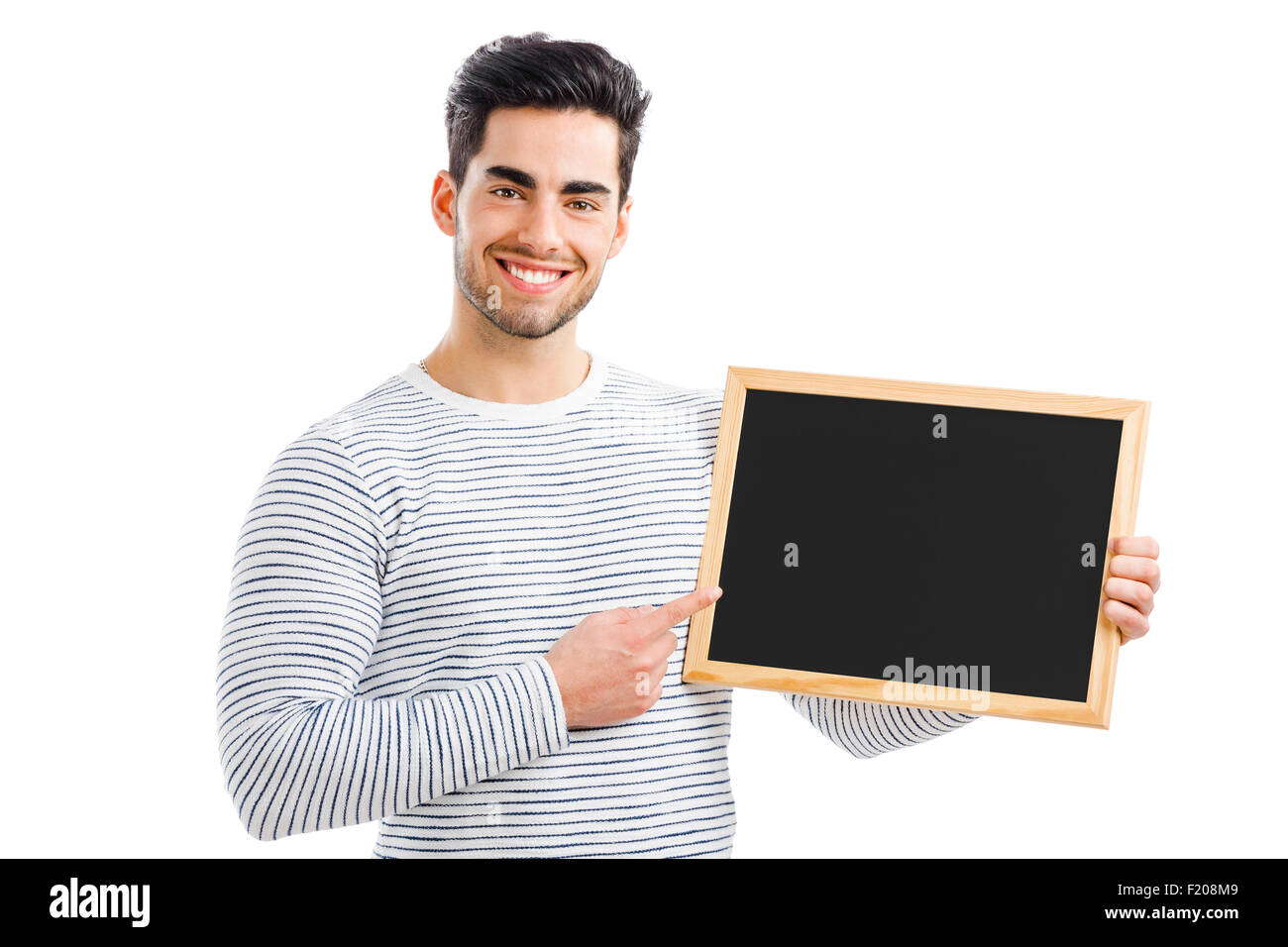 Hübscher junger Mann halten und deutete auf eine kleine Tafel, auf einem weißen Hintergrund isoliert Stockfoto