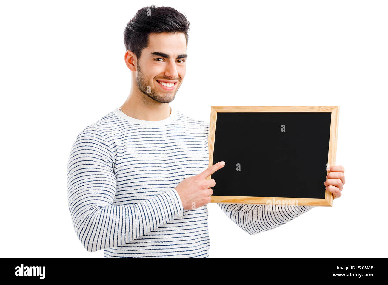 Hübscher junger Mann halten und deutete auf eine kleine Tafel, auf einem weißen Hintergrund isoliert Stockfoto
