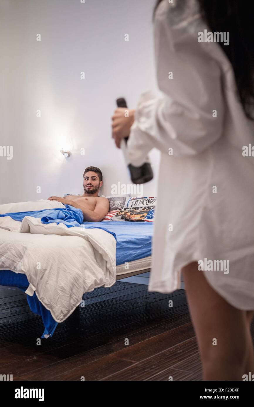 Junger Mann im Bett warten Freundin Stockfoto