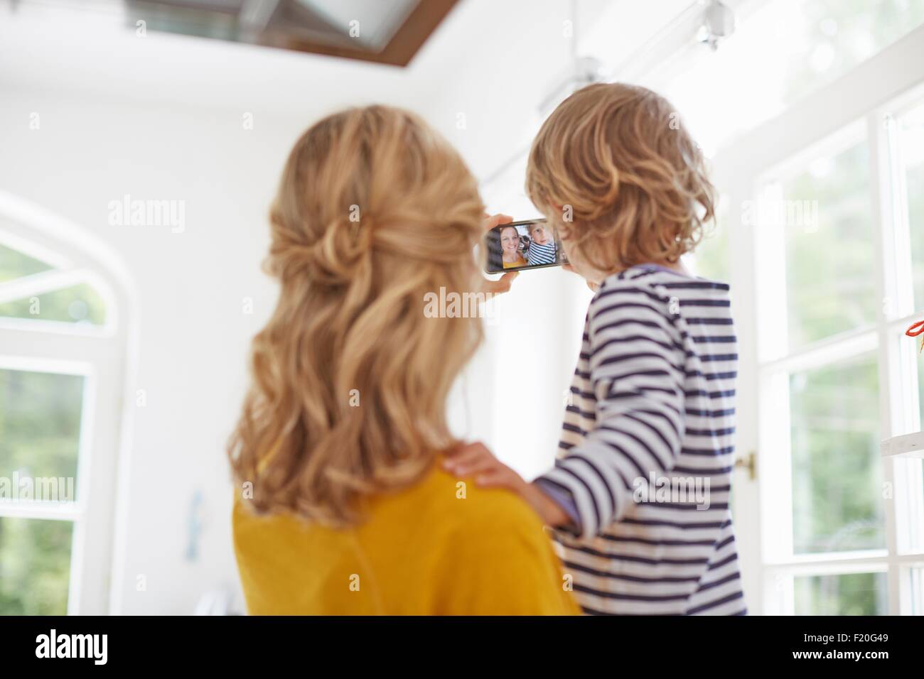 Mutter und Sohn unter Selfie in Küche Stockfoto