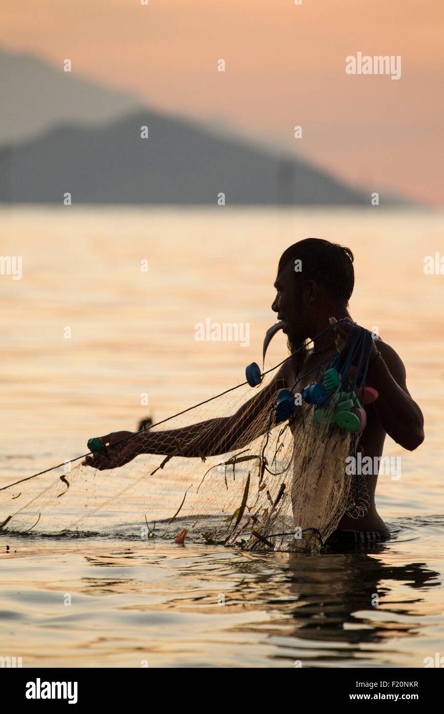 Indonesien, kleinen Sunda-Inseln, Alor Archipel, Insel Pantar, Kabir, Fischer sein Netz ziehen, bei Sonnenuntergang Stockfoto