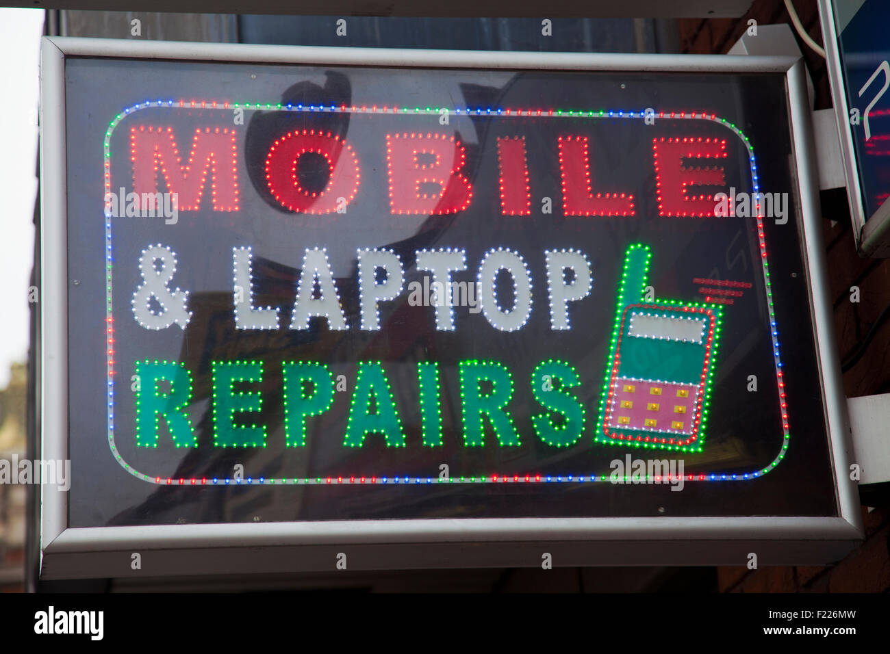 Handy, Laptop Reparaturen Led Zeichen Stockfoto