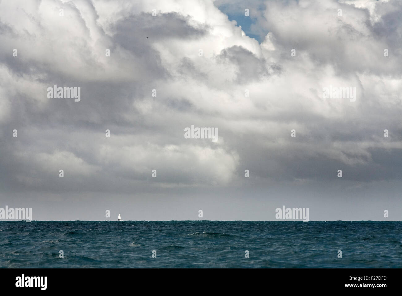 Himmel und Meer, Segelboot am fernen Horizont Stockfoto