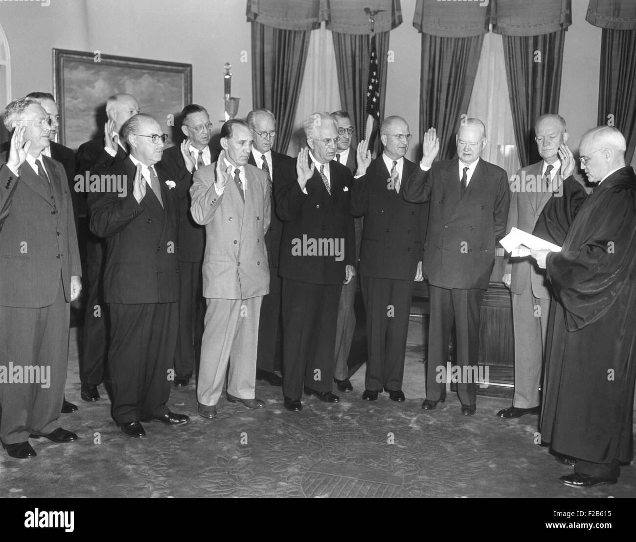 Vereidigung der zweiten Hoover-Kommission von Gerechtigkeit Harold H. Burton (rechts). 80 Jahre alten ehemaligen Präsidenten Herbert Hoover neben Präsident Dwight Eisenhower steht. Siebte ist von links Joseph. 29. September 1953. -(BSLOC 2014 16 189) Stockfoto