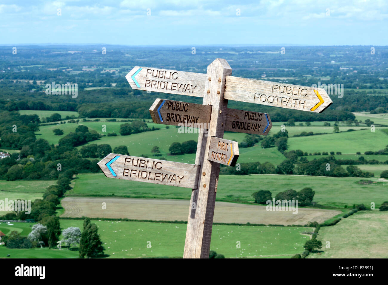 Wanderweg-Wegweiser in sechs Richtungen auf den South Downs in der Nähe von Devil es Dyke, West Sussex. Mit schöner Aussicht in den Hintergrund. Stockfoto