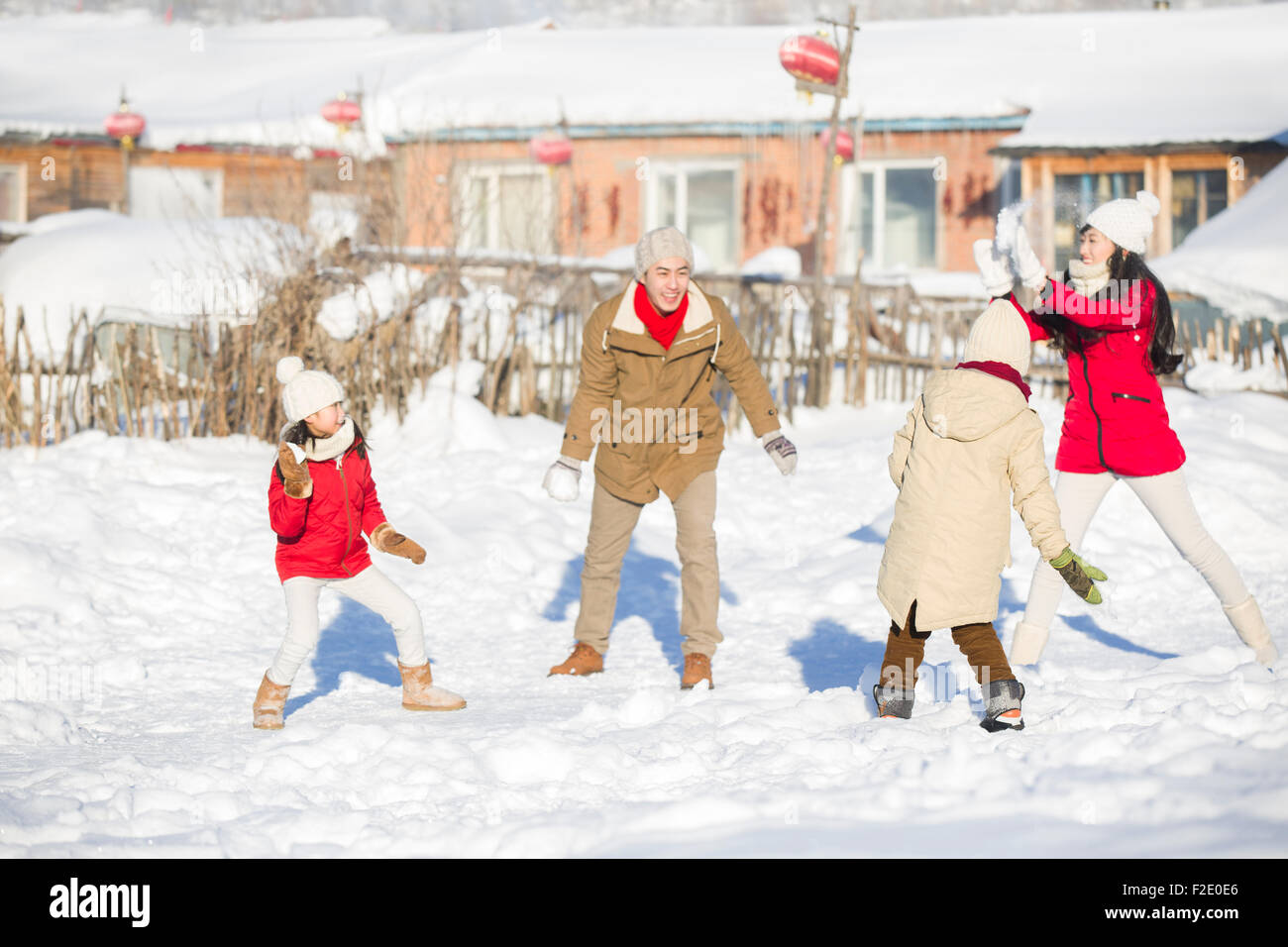 Junge Familie mit einer Schneeballschlacht im Schnee Stockfoto
