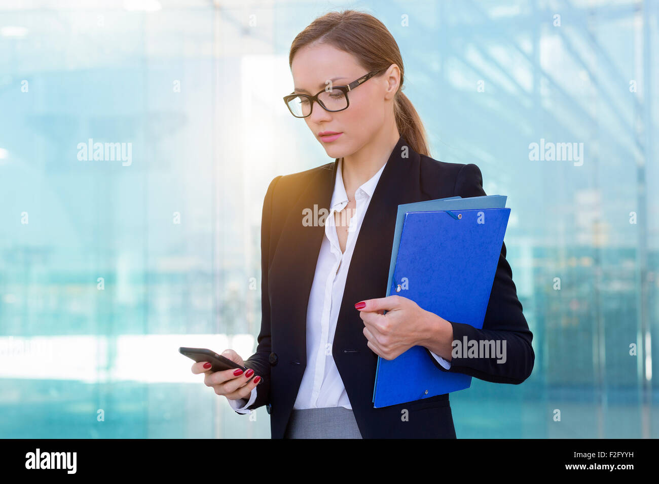 Geschäftsfrau, die mit einem smart-phone Stockfoto