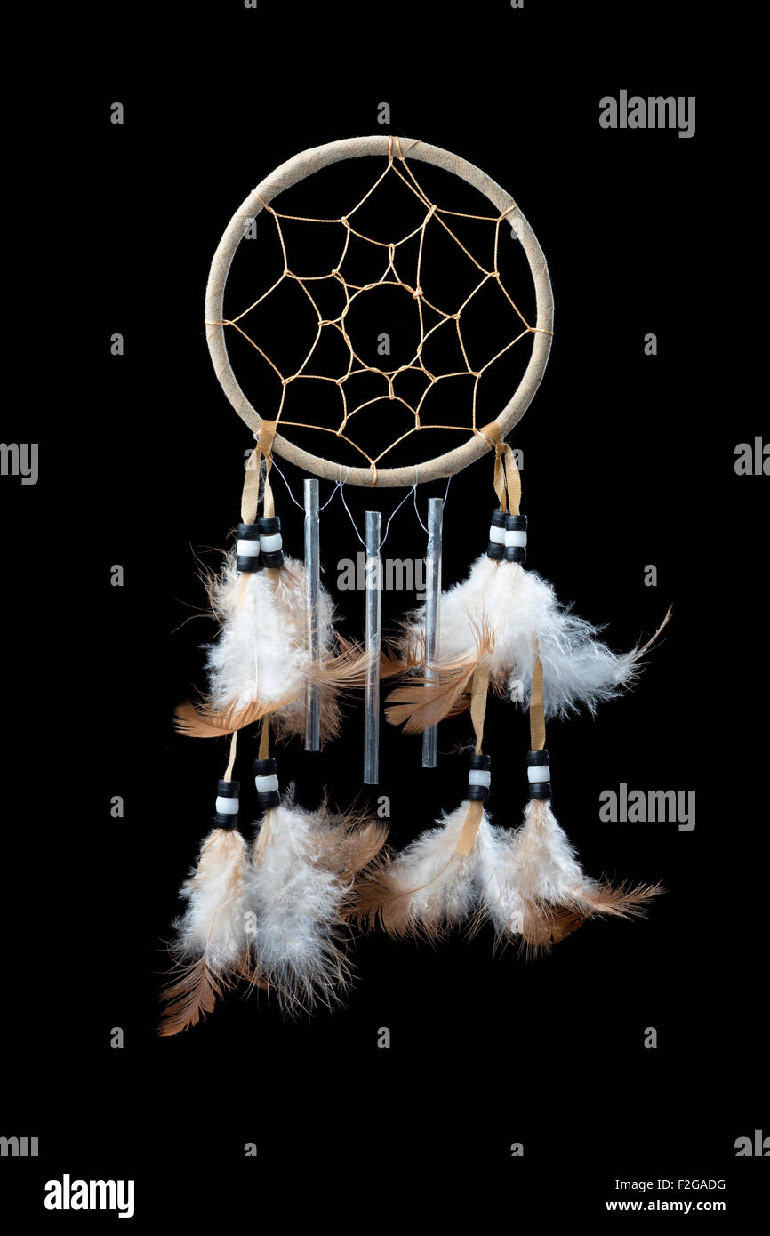 Eine kleine Traumfänger mit Federn, Perlen und Glockenspiel auf einem rein schwarzen Hintergrund Stockfoto