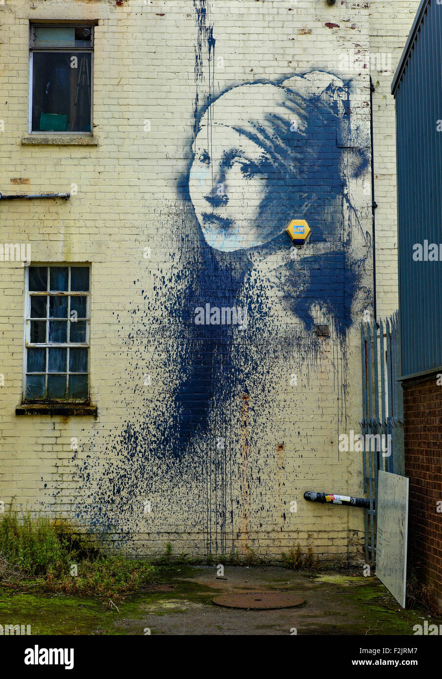 Banksy's Mädchen mit einem Trommelfell durchbohrt Graffiti auf einem Gebäude von Bristols schwimmenden Hafen Stockfoto