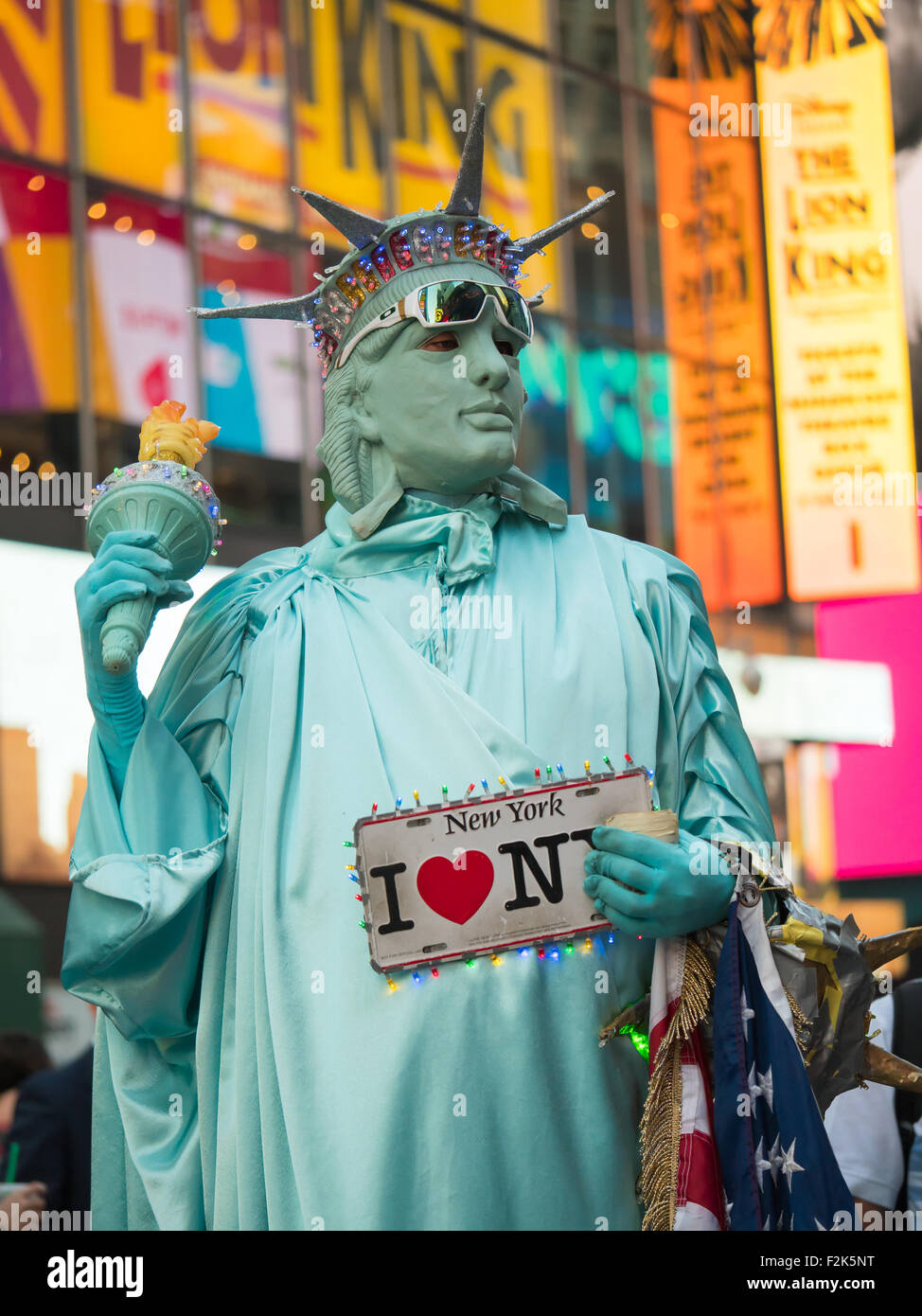 Eine Darsteller in einem New Yorker Freiheitsstatue Kostüm arbeitet sucht Tipps für Fotos mit Touristen auf dem Times Square in New York City. Stockfoto