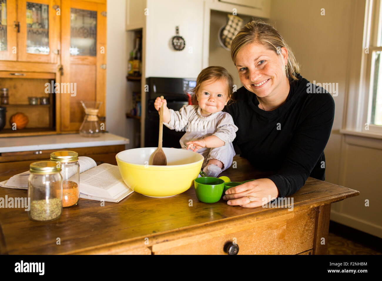 Kaukasische Mutter und Babymädchen in Küche Backen Stockfoto