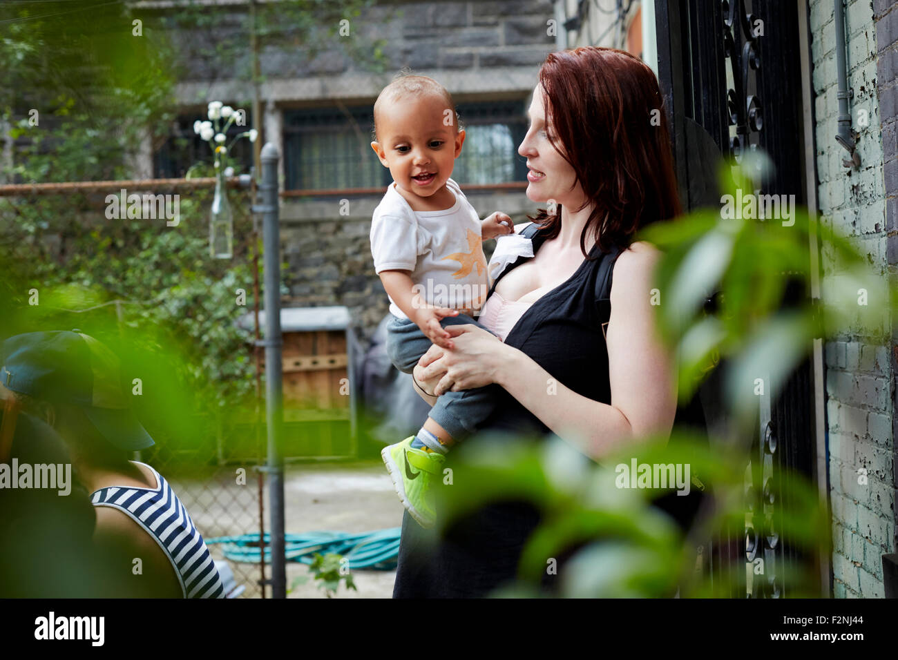 Frau mit Baby Sohn im Hinterhof Stockfoto