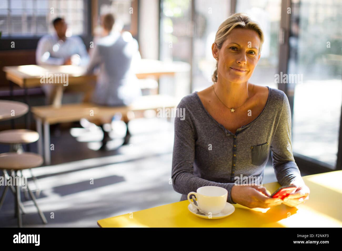 Frau mit Handy im café Stockfoto