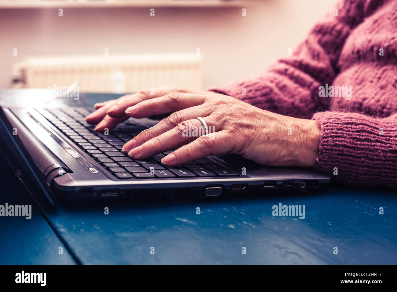 die Hände einer reifen Frau, die Eingabe über die Tastatur Stockfoto