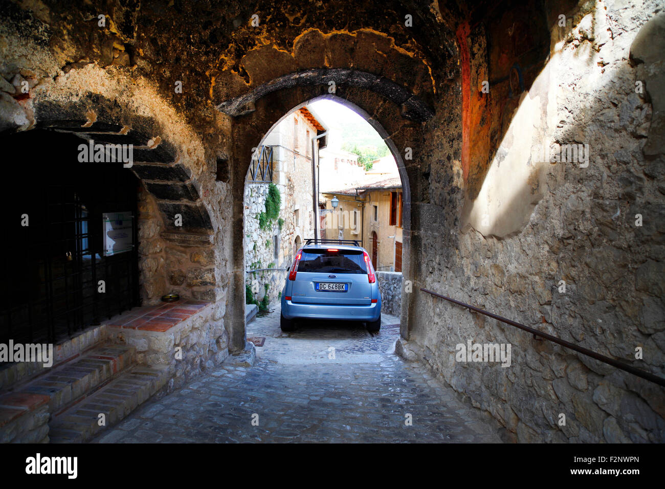 Ein Auto verhandelt die engen Straßen in dem mittelalterlichen Dorf Fontecchio in Italien. Stockfoto