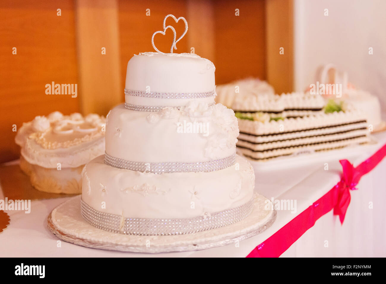 Ein Multi Level weiße Hochzeitstorte auf einen Tisch gelegt Stockfoto