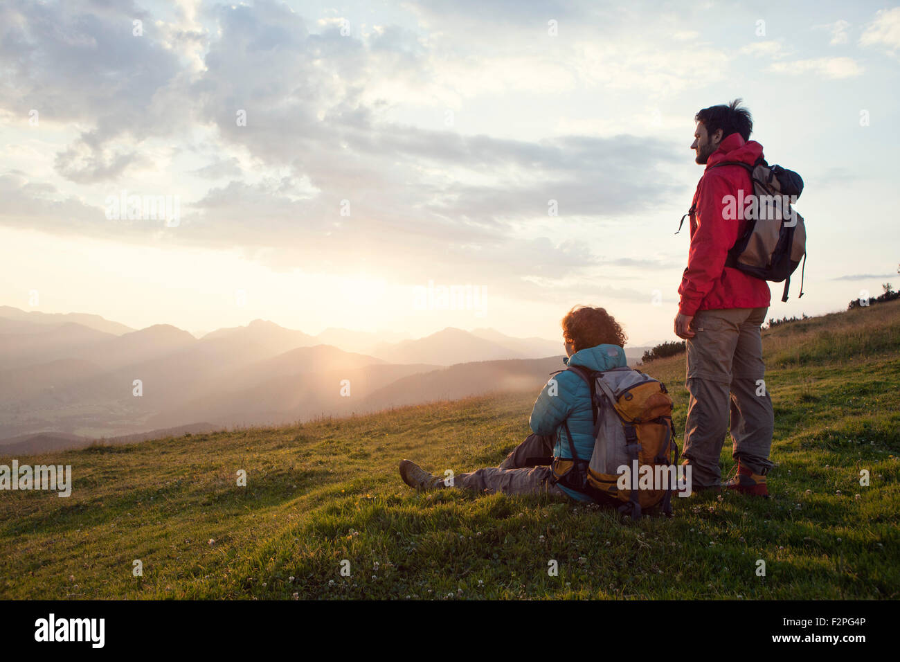 Österreich, Tirol, Unterberghorn, zwei Wanderer ruht in alpiner Landschaft bei Sonnenaufgang Stockfoto