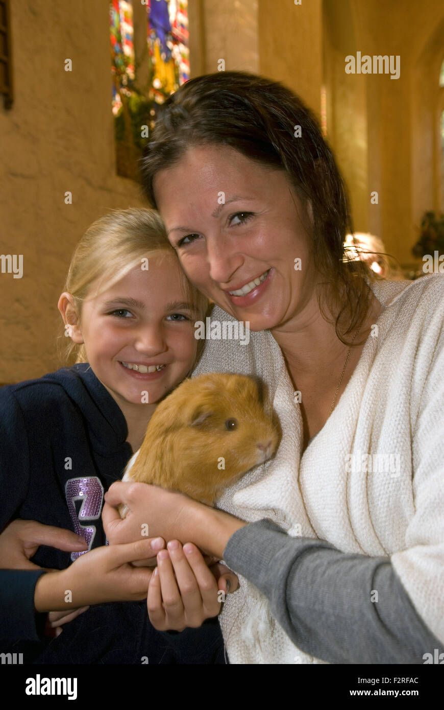 Mutter und 10 jährige Tochter und ihre Meerschweinchen an der Kirche, in die Gemeinde eingeladen wurden, mitbringen... P Stockfoto