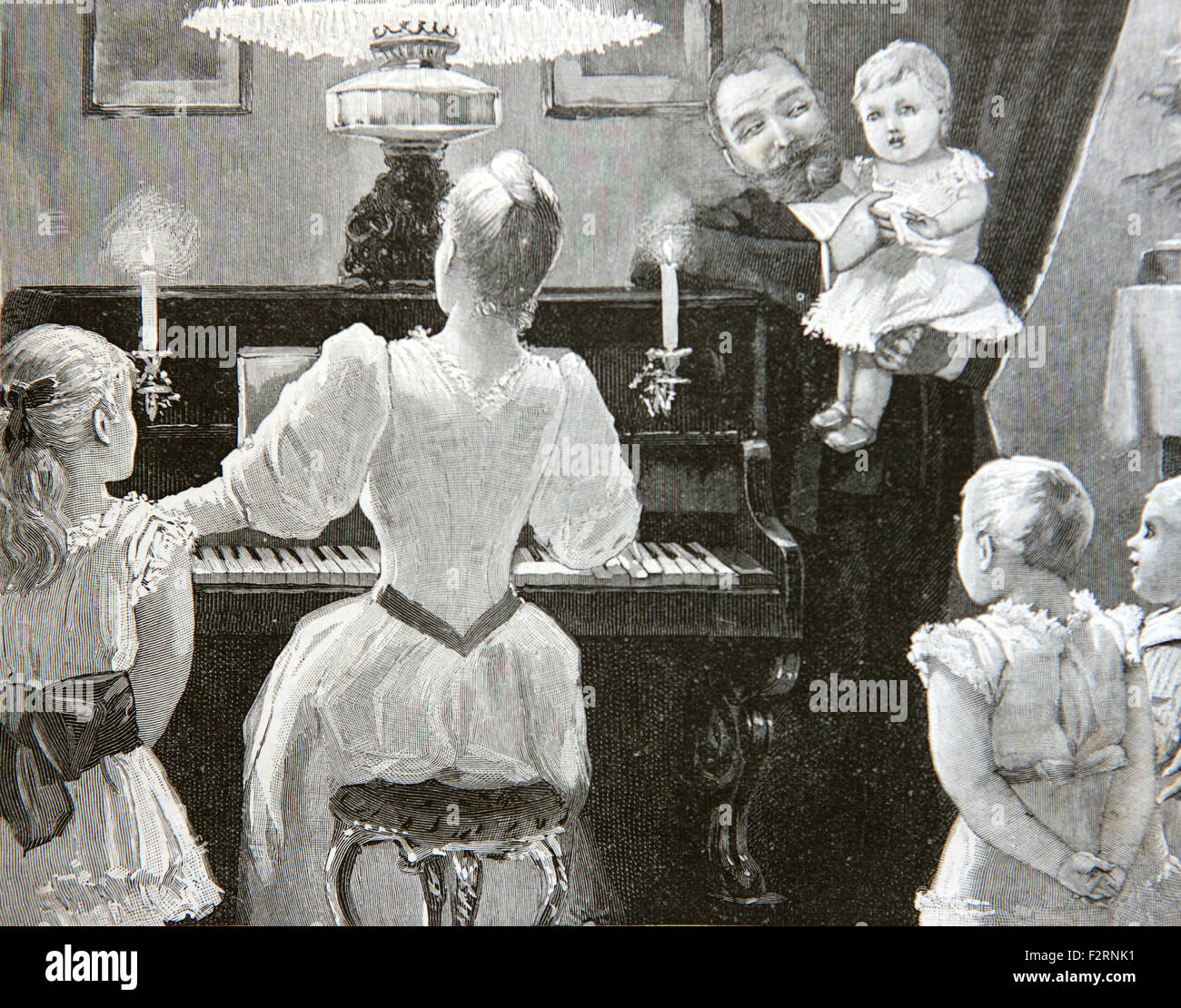 Edwardian Familie ein Lied singen, um das Klavier. Stockfoto