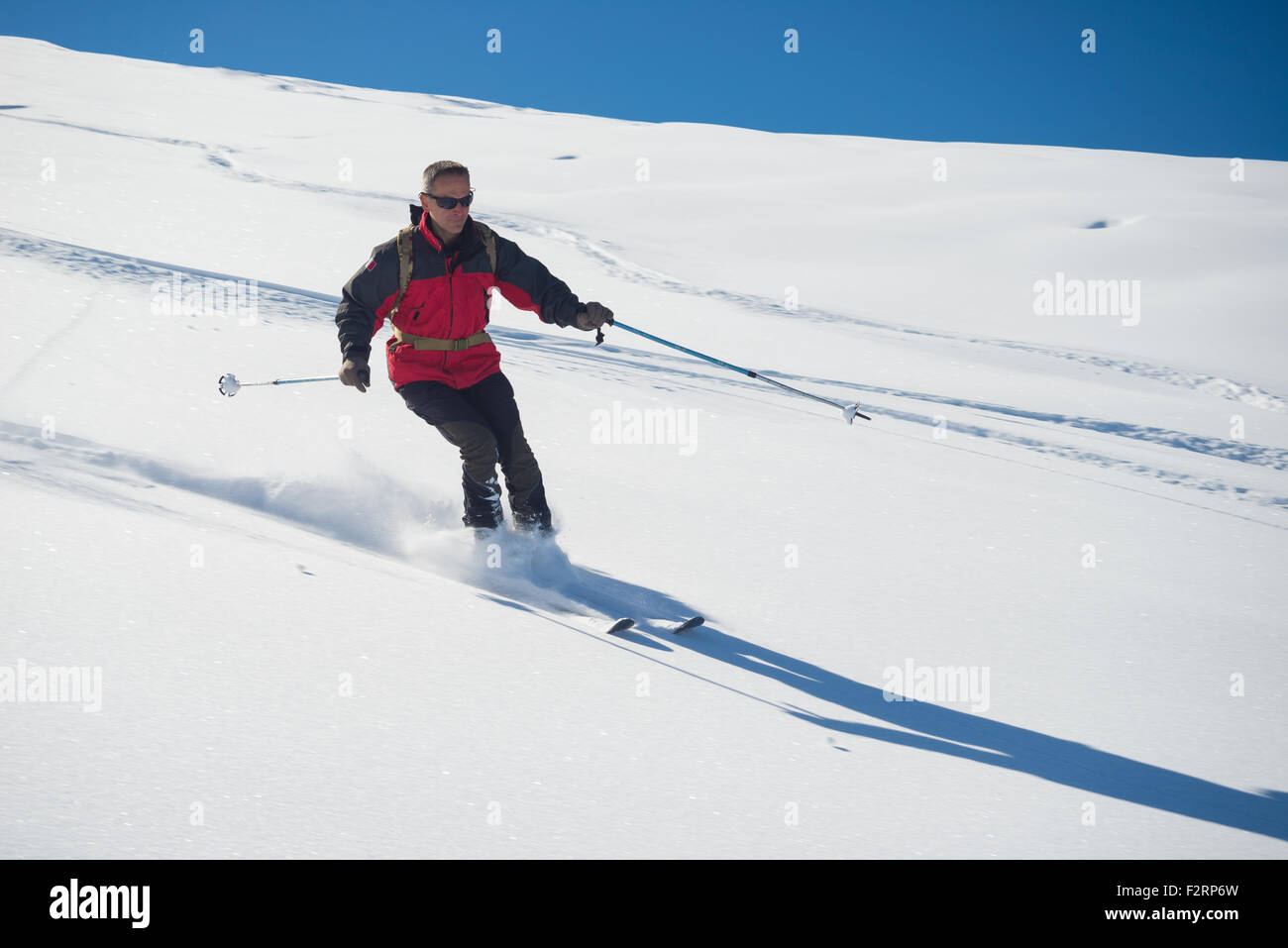 Eine Person, Ski Abfahrten abseits der Piste auf verschneiten Hang in den italienischen Alpen, mit hellen, sonnigen Tag der Winter-Saison. Dicken Pulver s Stockfoto