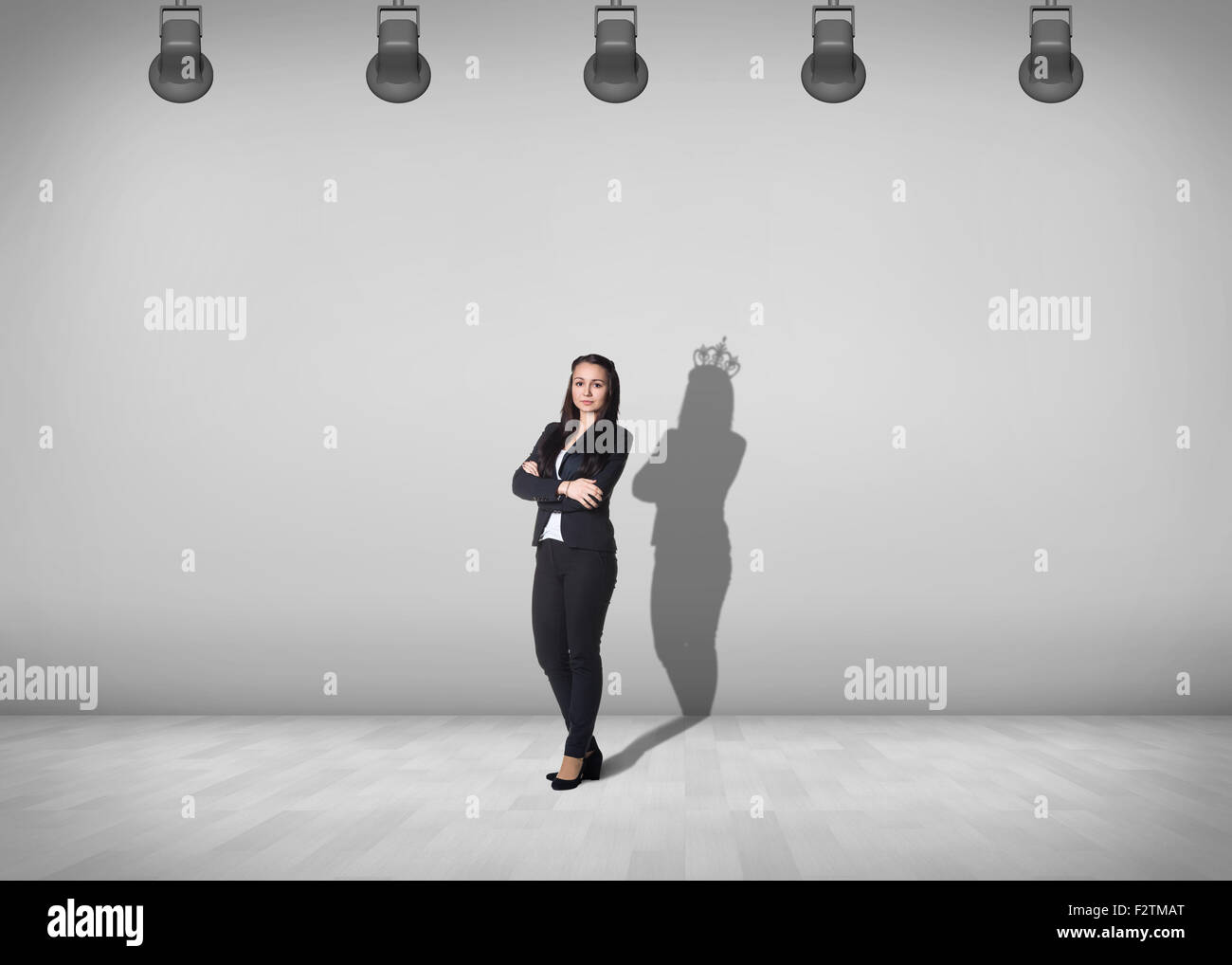 Geschäftsfrau steht mit Schatten an der Wand Stockfoto
