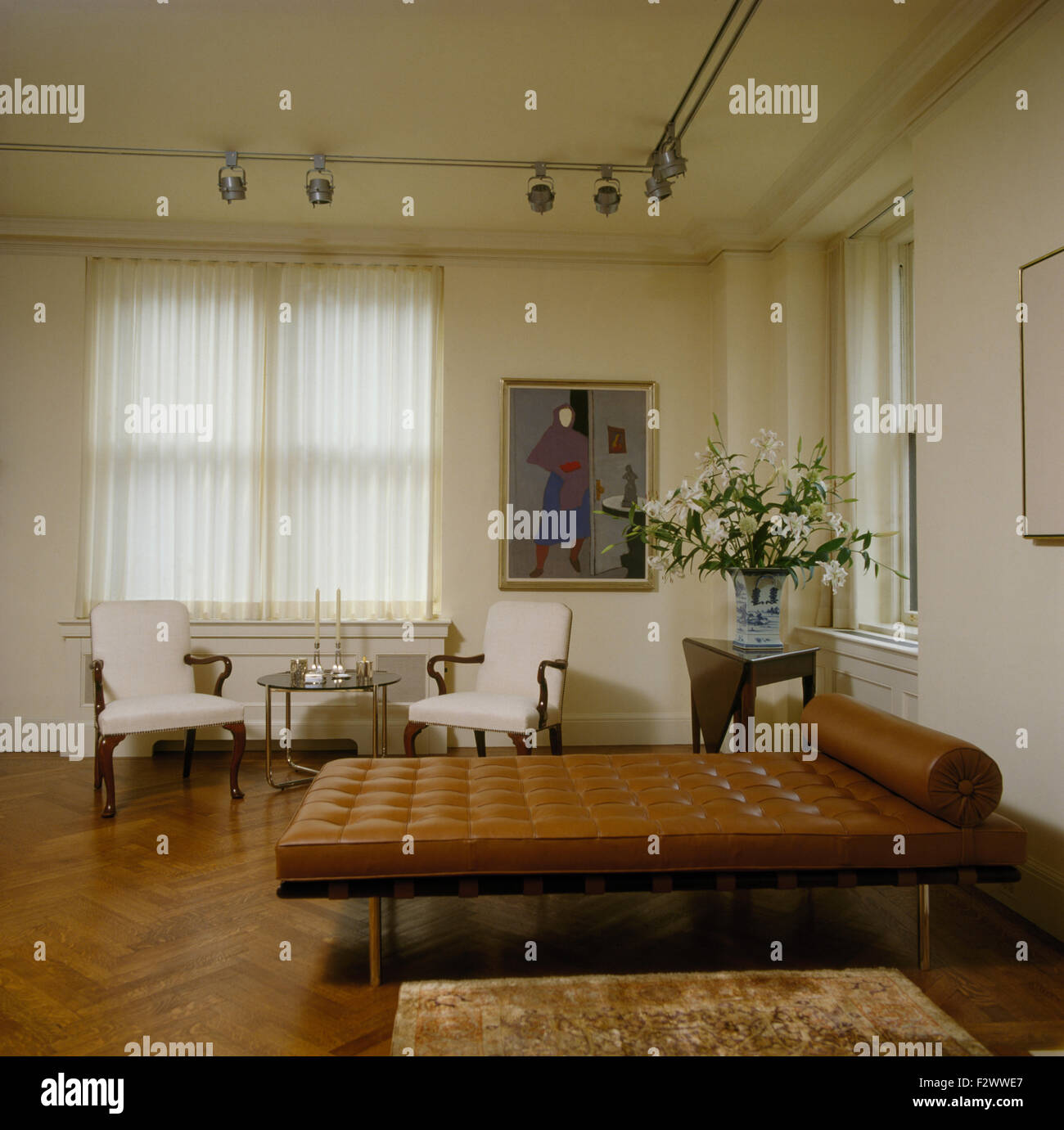 Braunes Leder zugeknöpft Chaiselongue in Wohnung Wohnzimmer mit Parkettboden Stockfoto