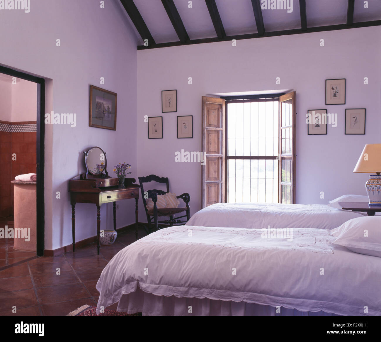 Weiße Bettdecken auf zwei Einzelbetten im Schlafzimmer des weißen spanischen Land Stockfoto