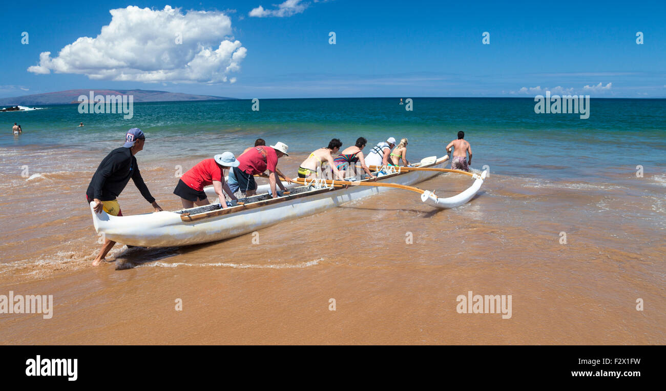 Touristen begeben Sie sich auf Ausleger-Kanu-Tour at Wailea Beach auf Maui Stockfoto