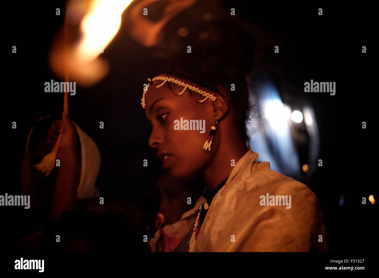 Äthiopisch-orthodoxe Christen halten die Kerze fest, während sie die ‘Demera’ feiern, Dies ist eine Zeremonie der Meskel - Entdeckung des wahren Kreuzes durch die heilige Helena im vierten Jahrhundert n. Chr., die am 27. September 2015 in der Grabeskirche in Ostjerusalem, Israel, durch Fackel am Deir El-Sultan Kloster auf dem Dach der Grabeskirche beobachtet wurde. Meskel, ist der geistliche Feiertag der orthodoxen Christen in Äthiopien und wird seit Tausenden von Jahren gefeiert. Sie wurde nun von der UNESCO auf die repräsentative Liste des immateriellen Kulturerbes der Menschheit gesetzt. Stockfoto