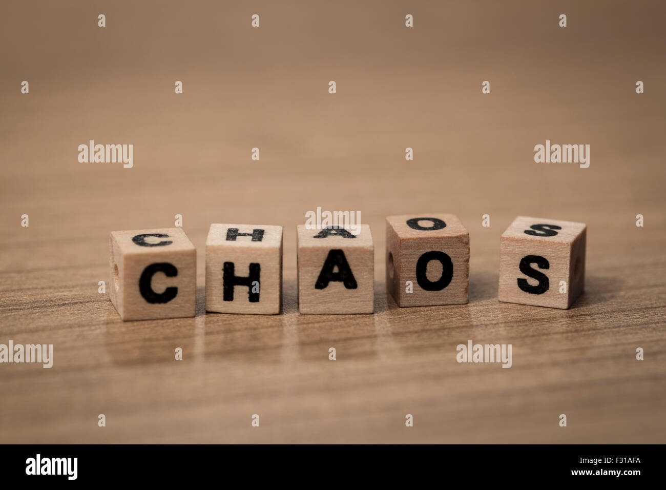 Chaos in chaotisch Reihenfolge geschrieben in hölzerne Würfel auf dem Schreibtisch Stockfoto
