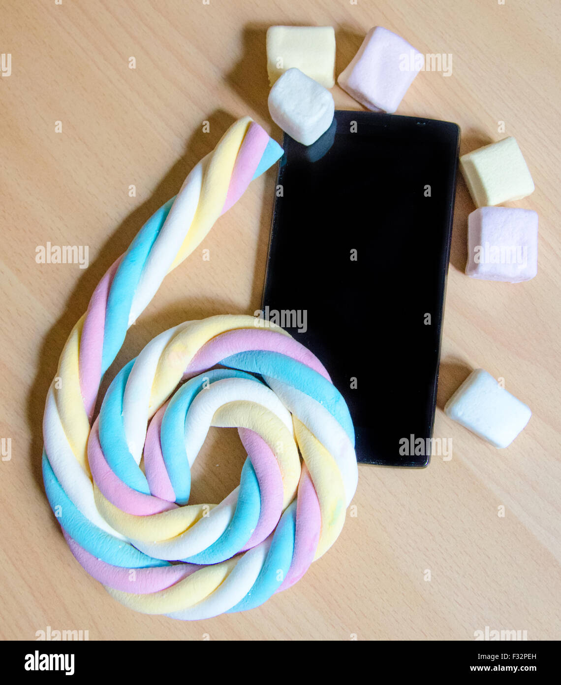 Handy mit farbigen Marshmallows Bonbons Stockfoto