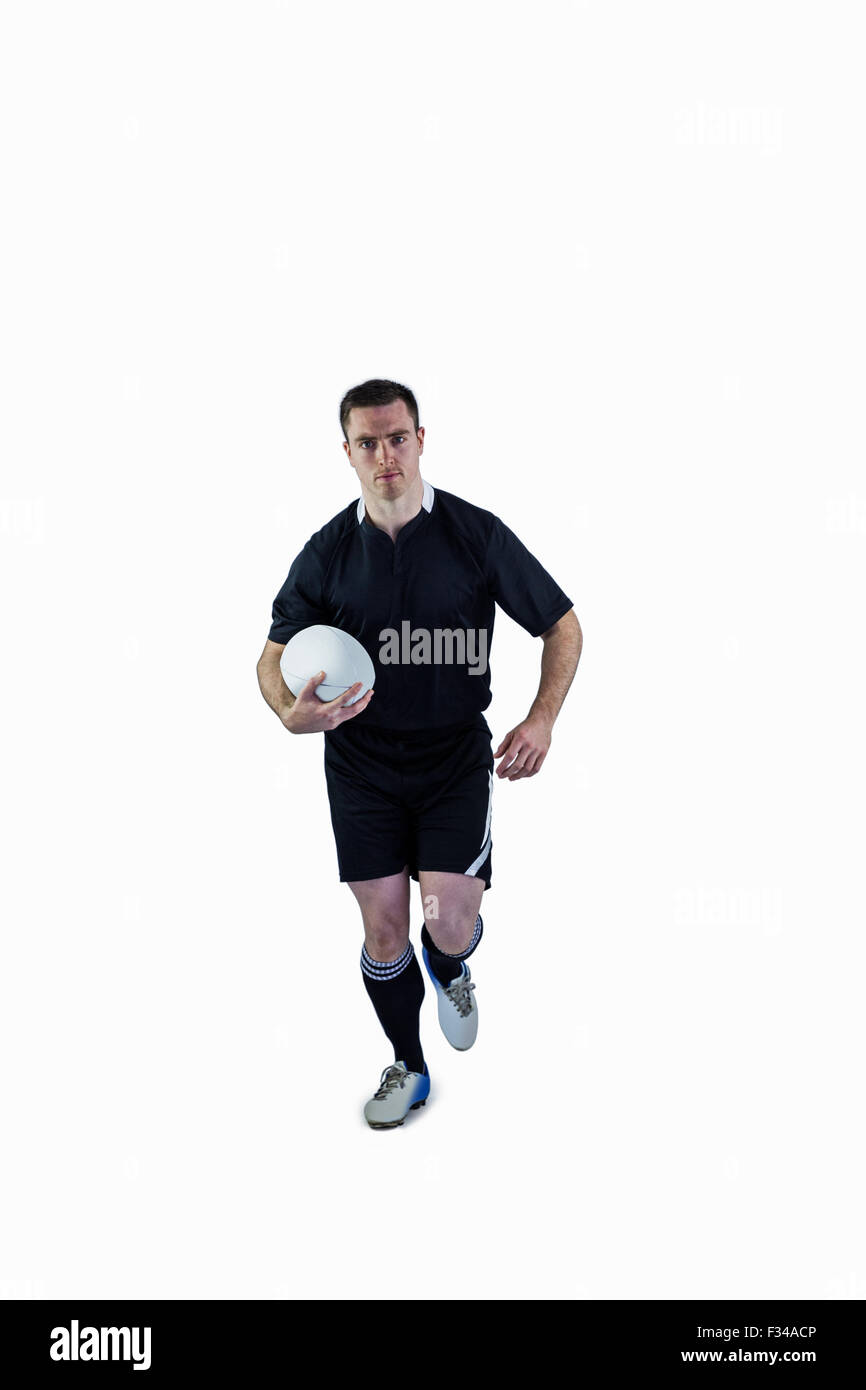 Rugby-Spieler läuft mit dem Rugby-ball Stockfoto