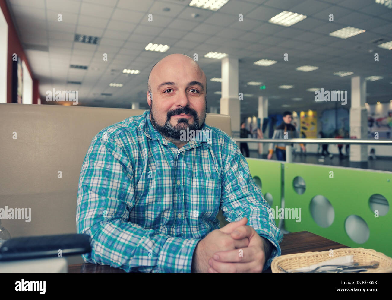 Ein bärtiger Mann in ein kariertes Hemd in der Tabelle-bar Stockfoto